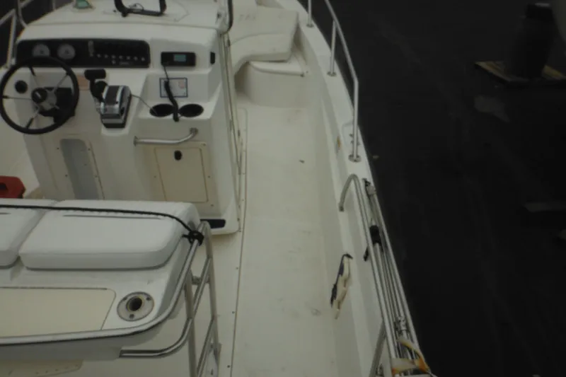 Slide: The Image of 2003 Boston Whaler 220 Dauntless boat interior with steering console and seating. - 16