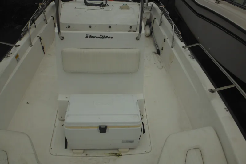 Slide: The Image of 2003 Boston Whaler 220 Dauntless boat interior with seating and storage cooler. - 25