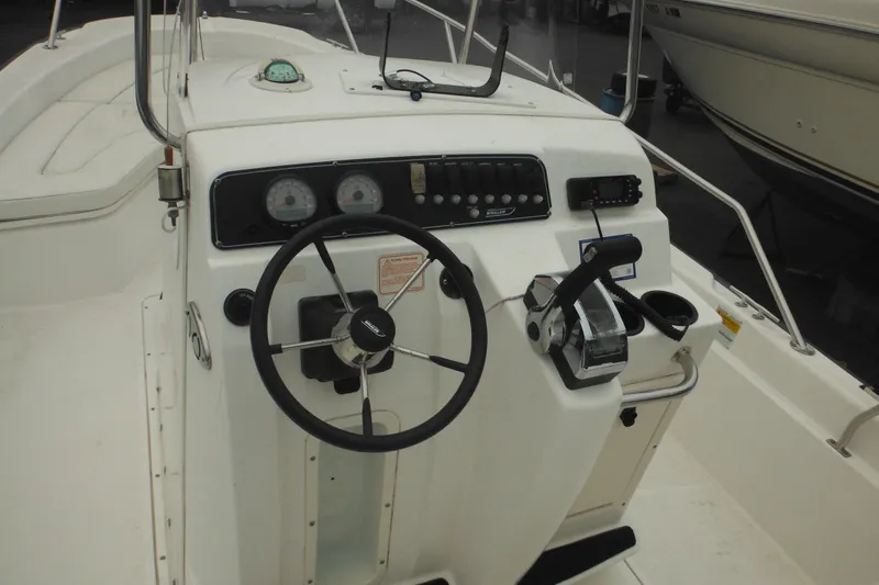 Slide: The Image of 2003 Boston Whaler 220 Dauntless boat console with steering wheel and controls. - 27