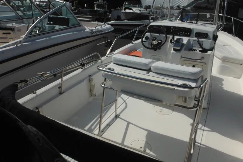 Slide: The Image of 2003 Boston Whaler 220 Dauntless boat interior with steering console and seating. - 34