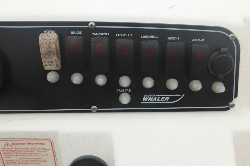 Slide: The Image of Control panel of a 2003 Boston Whaler 220 Dauntless boat with various switches. - 29