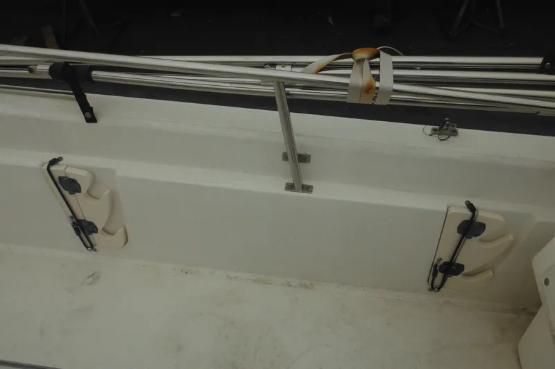 Slide: The Image of Interior view of a 2003 Boston Whaler 220 Dauntless boat, featuring rod holders. - 31