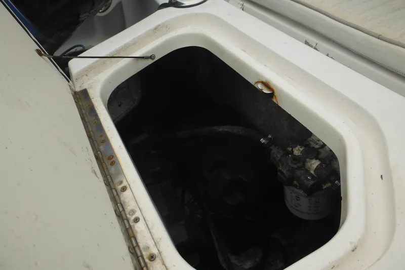 Slide: The Image of Open compartment of a 2003 Boston Whaler 220 Dauntless boat, showing internal components. - 10