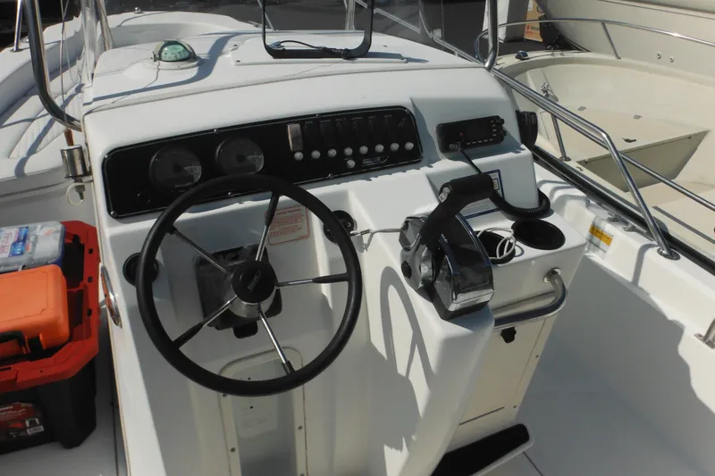 Slide: The Image of 2003 Boston Whaler 220 Dauntless boat console with steering wheel and controls. - 46