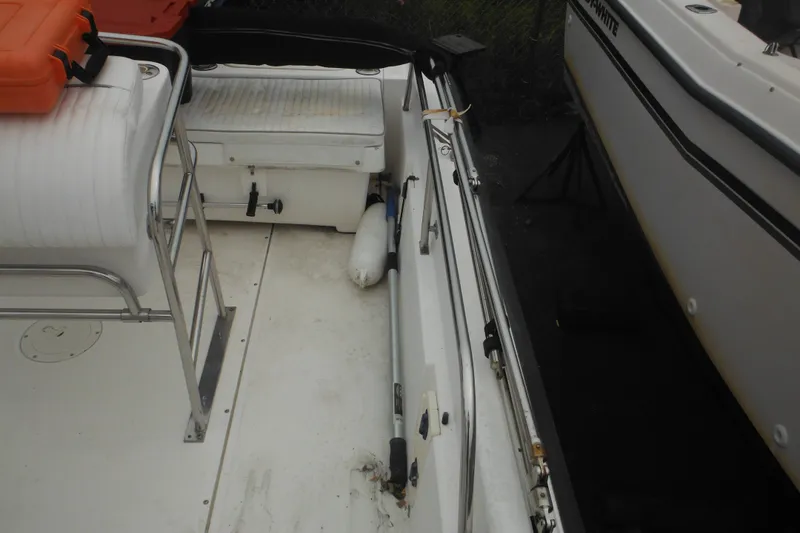Slide: The Image of Interior view of a 2003 Boston Whaler 220 Dauntless boat, showcasing seating and storage. - 26