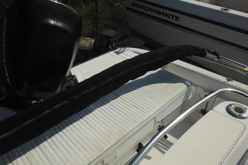 Slide: The Image of 2003 Boston Whaler 220 Dauntless boat interior with seating and motor. - 38