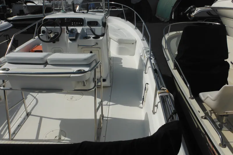 Slide: The Image of 2003 Boston Whaler 220 Dauntless boat interior with steering console and seating. - 33