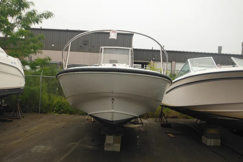Slide: The Image of 2003 Boston Whaler 220 Dauntless boat on blocks in a storage yard. - 5