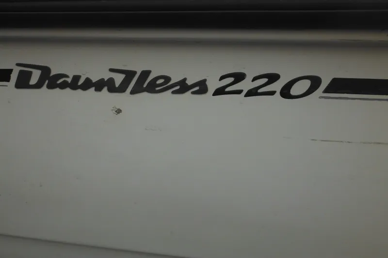 Slide: The Image of Close-up of 2003 Boston Whaler 220 Dauntless boat model name on hull. - 7
