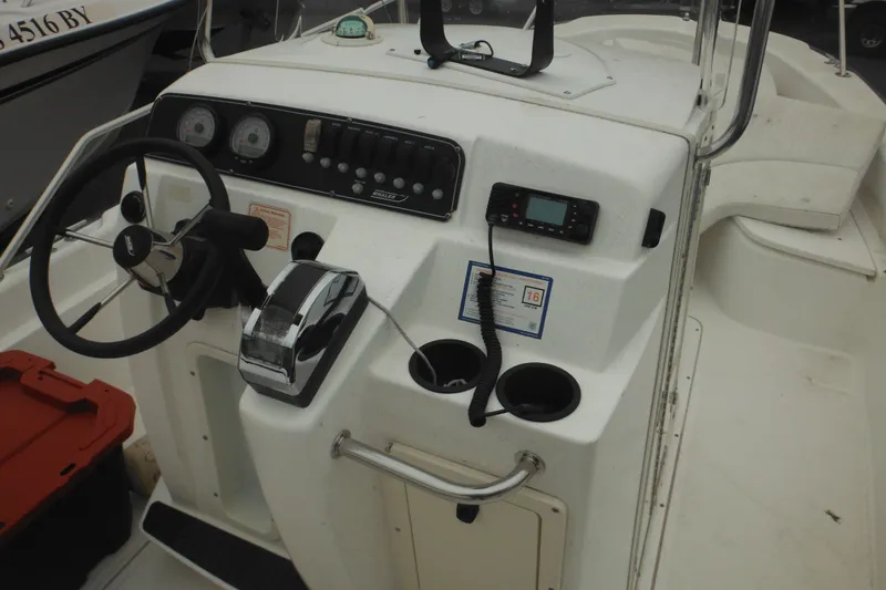 Slide: The Image of 2003 Boston Whaler 220 Dauntless boat console with steering wheel and controls. - 18
