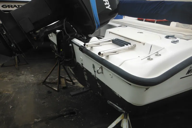 Slide: The Image of 2003 Boston Whaler 220 Dauntless boat with outboard motor and swim ladder. - 9