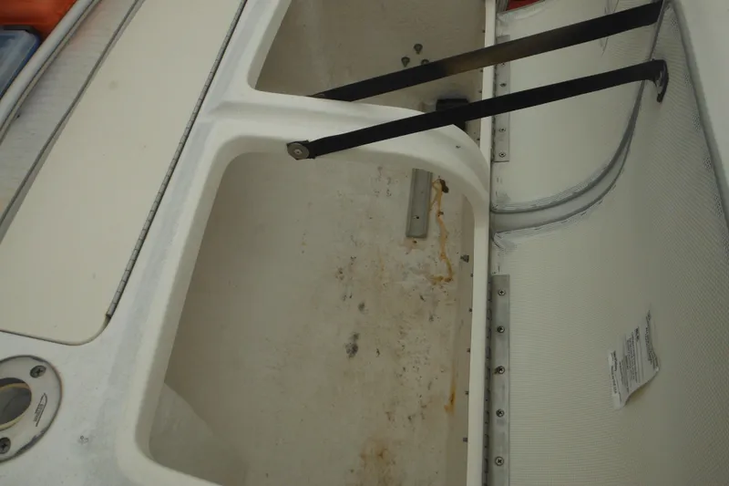 Slide: The Image of Storage compartment of a 2003 Boston Whaler 220 Dauntless boat, showing interior details. - 20