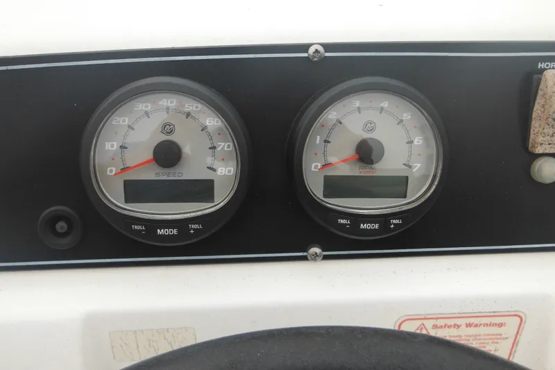 Slide: The Image of Dashboard of a 2003 Boston Whaler 220 Dauntless boat with speed and RPM gauges. - 28