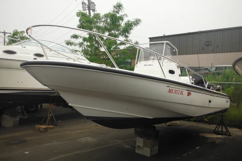 Slide: The Image of 2003 Boston Whaler 220 Dauntless boat on display in a marina setting. - 6