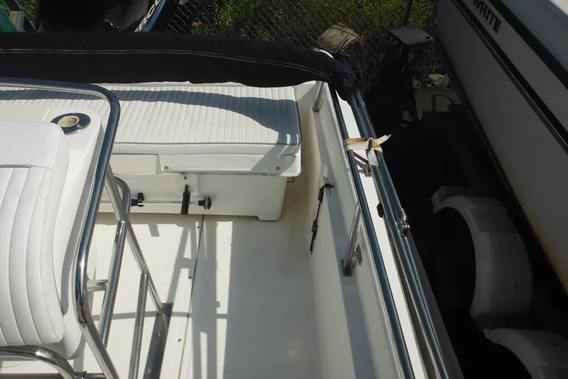 Slide: The Image of Interior view of a 2003 Boston Whaler 220 Dauntless boat, featuring seating and railing. - 41