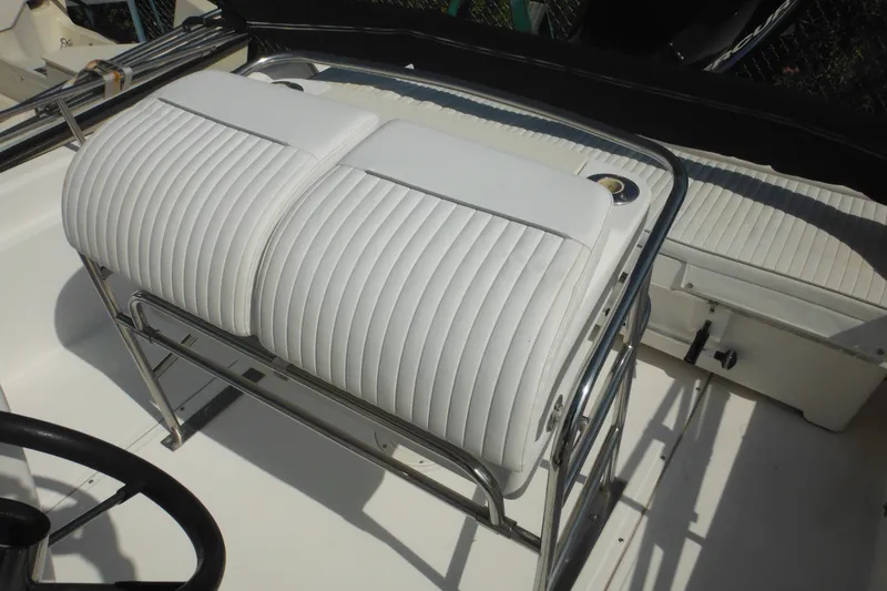 Slide: The Image of Boston Whaler 220 Dauntless 2003 boat interior with white cushioned seating. - 40