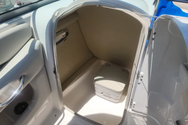 Slide: The Image of 2008 Chaparral 246 SSi boat interior with compact portable toilet in storage compartment. - 6
