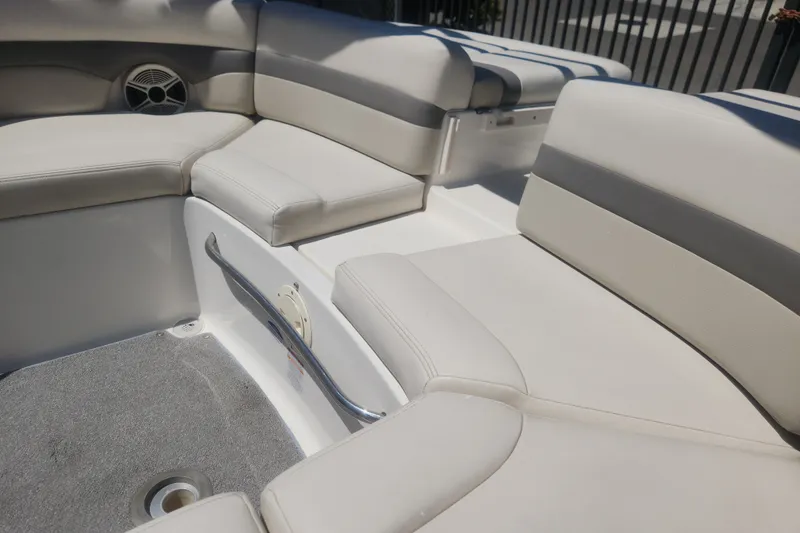 Slide: The Image of 2008 Chaparral 246 SSi boat interior with beige seating and speaker detail. - 2