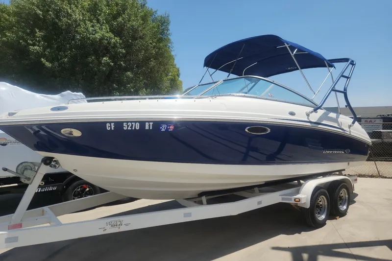 Slide: The Image of 2008 Chaparral 246 SSi boat on trailer, blue and white design, parked outdoors. - 8