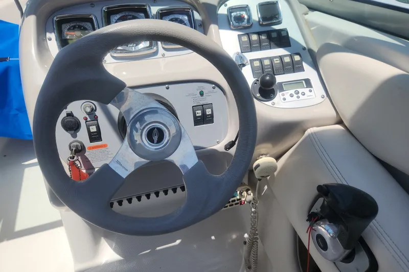 Slide: The Image of Steering console of a 2008 Chaparral 246 SSi boat with controls and gauges. - 5