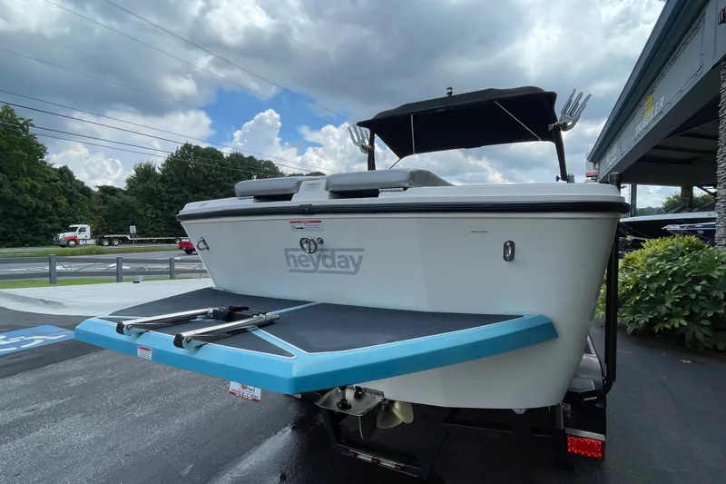 Slide: The Image of 2017 Heyday WT-2 boat with swim platform, parked outdoors under cloudy sky. - 8