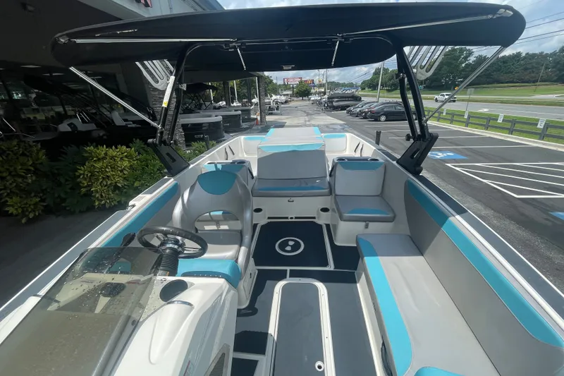 Slide: The Image of 2017 Heyday WT-2 boat interior with seating, steering wheel, and canopy in a parking lot. - 13