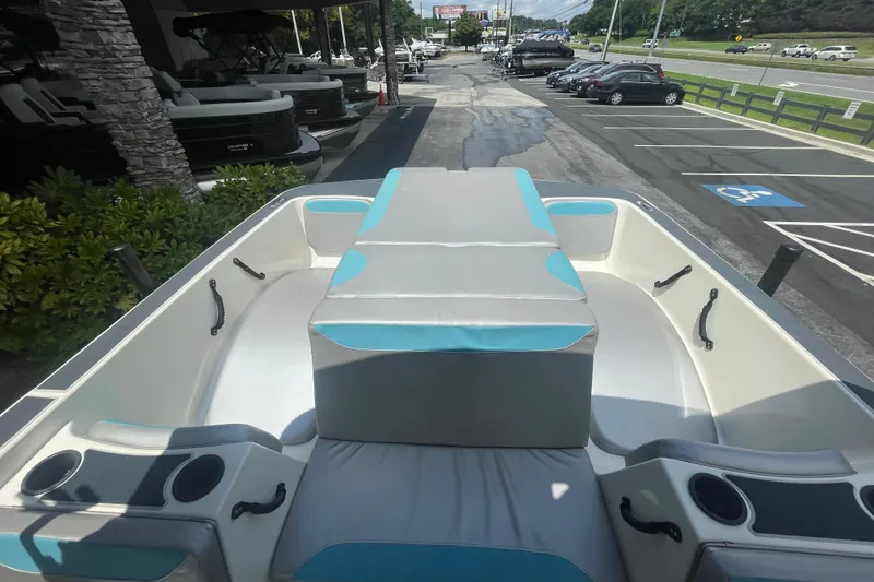 Slide: The Image of 2017 Heyday WT-2 boat interior with seating and cup holders in a parking lot. - 16