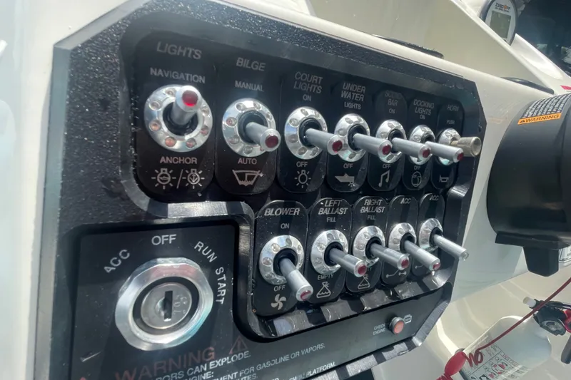Slide: The Image of Control panel of a 2017 Heyday WT-2 boat with various switches and ignition key. - 4
