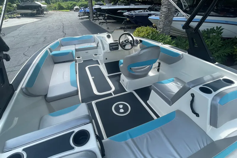 Slide: The Image of 2017 Heyday WT-2 boat interior with blue and gray seating, steering wheel, and cup holders. - 1