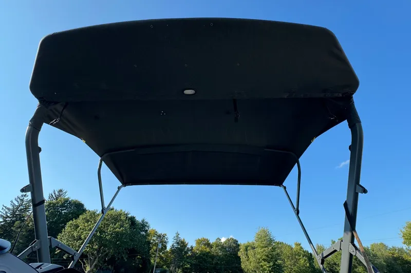 Slide: The Image of 2025 Sea-Doo Switch Fish 21 canopy against clear blue sky and trees. - 13