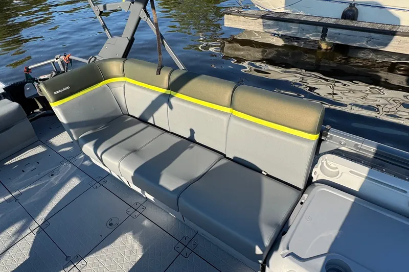 Slide: The Image of 2025 Sea-Doo Switch Fish 21 boat interior with gray seating and yellow accents. - 9