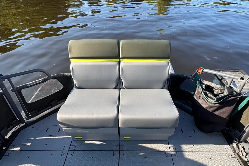 Slide: The Image of 2025 Sea-Doo Switch Fish 21 boat interior with gray seating on calm water. - 10