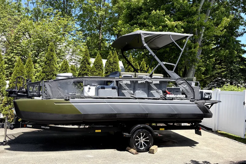The Image of 2025 Sea-Doo Switch Fish 21 boat on trailer, surrounded by lush greenery. - 0