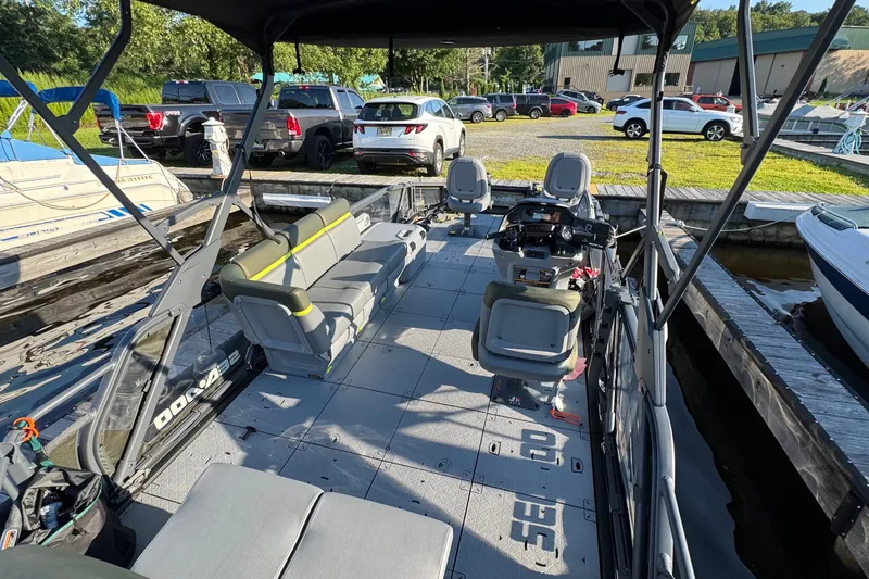 Slide: The Image of 2025 Sea-Doo Switch Fish 21 pontoon boat interior at marina dock. - 2