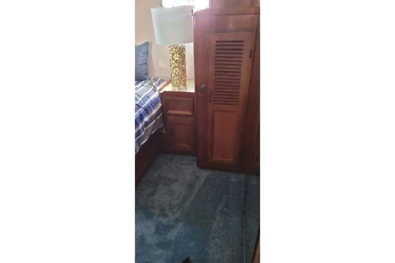 Slide: The Image of Cozy cabin interior with wooden furniture and blue carpet on a 1978 Symbol Double Deck Cockpit yacht. - 7