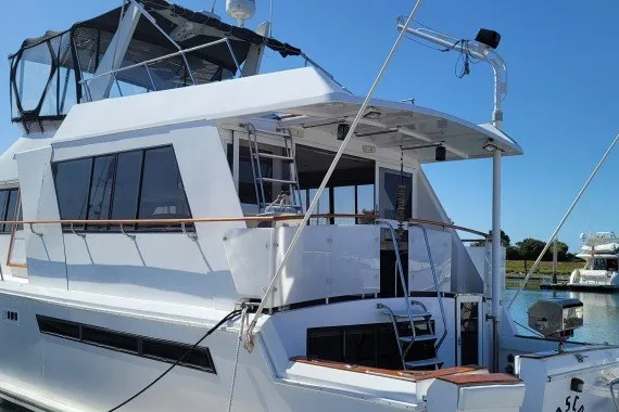 The Image of 1978 Symbol Double Deck Cockpit MY - 68' yacht docked in a marina under clear blue sky. - 1