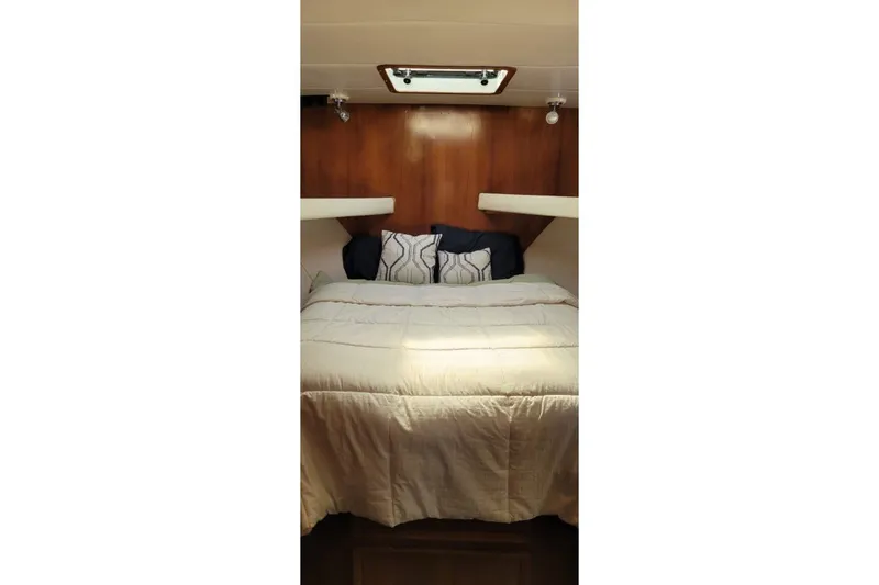 Slide: The Image of Cozy bedroom interior of 1978 Symbol Double Deck Cockpit MY yacht with wood paneling. - 5