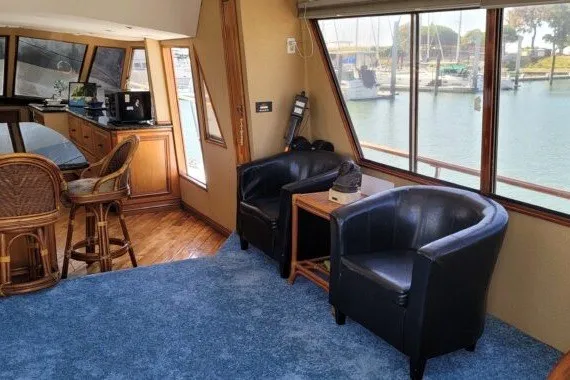 Slide: The Image of Interior of a 1978 Symbol Double Deck Cockpit MY yacht with blue carpet and leather chairs. - 13