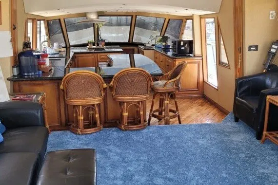 Slide: The Image of Luxurious 1978 Symbol Double Deck Cockpit yacht interior with kitchen and seating area. - 12