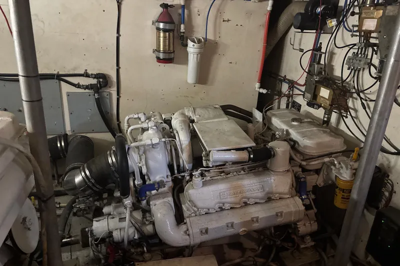 Slide: The Image of Engine room of a 1987 Symbol MS Super Sedan 60' with visible machinery and wiring. - 18