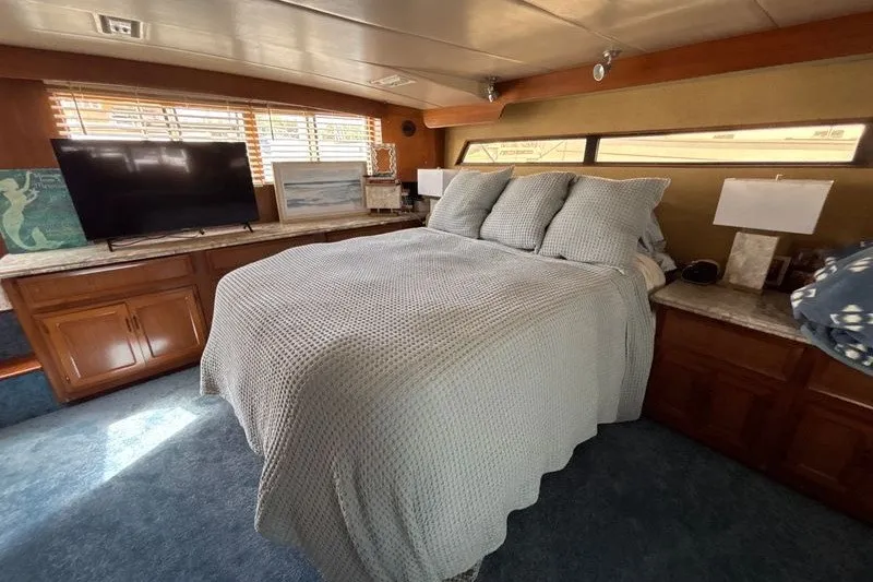 Slide: The Image of Cozy bedroom in 1987 Symbol MS Super Sedan yacht with TV and wooden cabinets. - 14