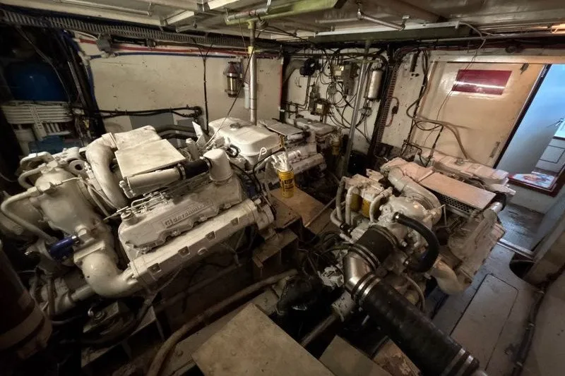 Slide: The Image of Engine room of a 1987 Symbol MS Super Sedan 60' yacht, showcasing dual engines. - 19