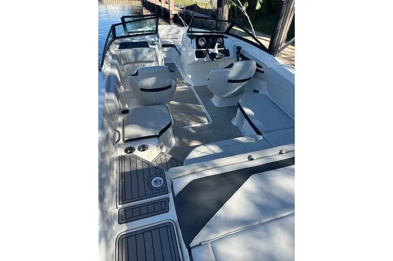 Slide: The Image of 2022 Sea Ray SPX 210 boat interior with seating and steering wheel. - 15