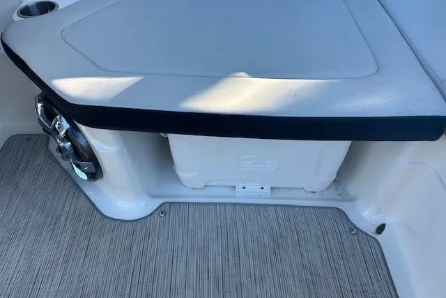 Slide: The Image of 2022 Sea Ray SPX 210 boat interior seating with storage compartment. - 16