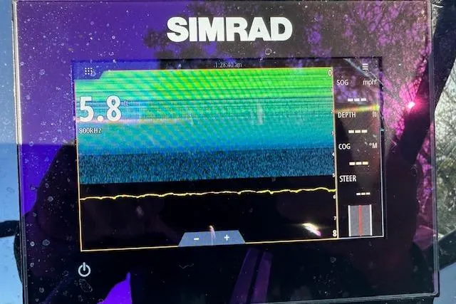 Slide: The Image of Simrad marine display on 2022 Sea Ray SPX 210 showing sonar and navigation data. - 26