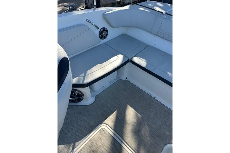 Slide: The Image of 2022 Sea Ray SPX 210 boat interior with cushioned seating and speaker system. - 14