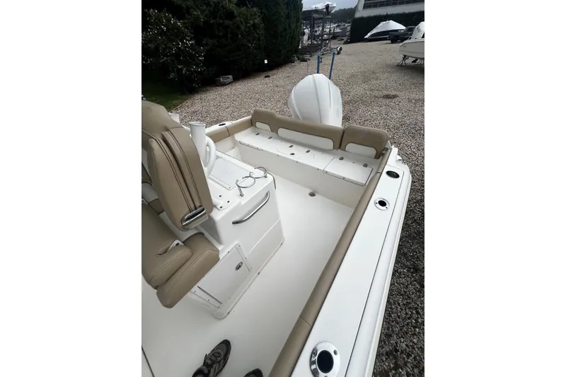 Slide: The Image of 2019 Key West 239 FS boat interior with beige seating and white deck. - 3