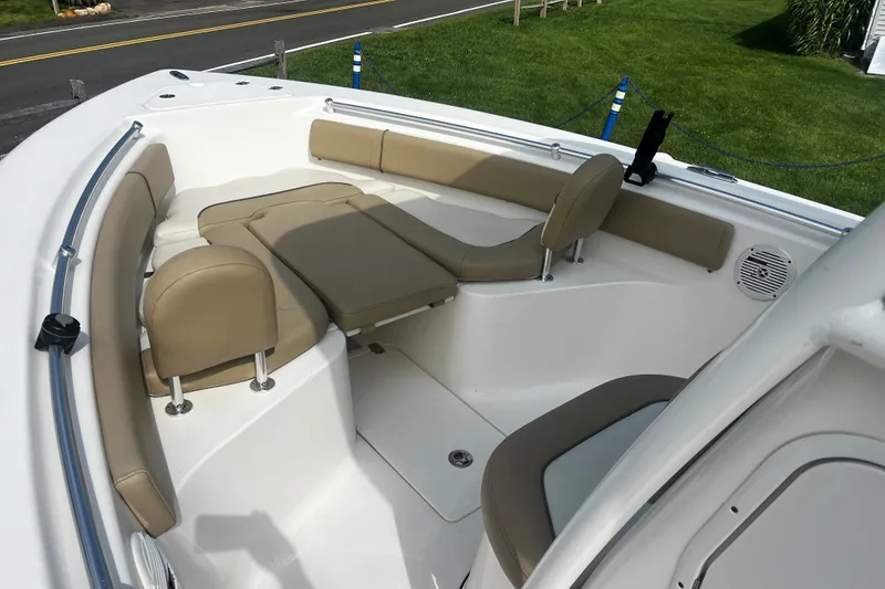 Slide: The Image of 2019 Key West 239 FS boat interior with beige seating and white deck. - 13