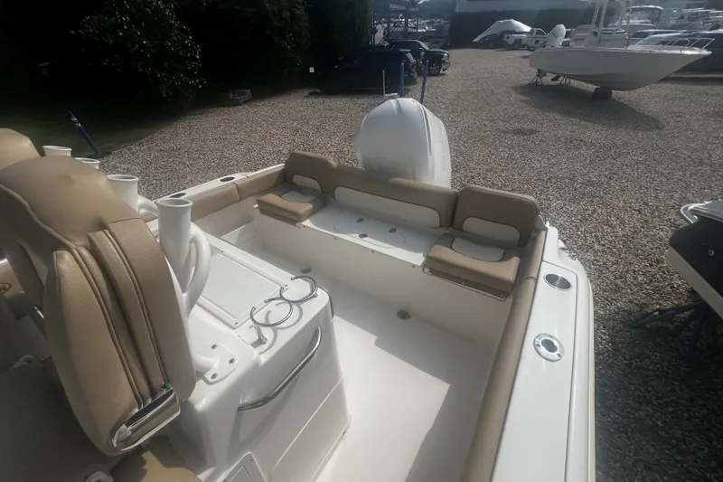 Slide: The Image of 2019 Key West 239 FS boat interior with tan seating and cup holders. - 4