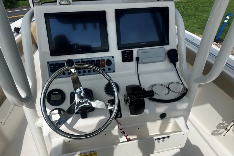 Slide: The Image of 2019 Key West 239 FS boat dashboard with steering wheel and dual Garmin displays. - 9